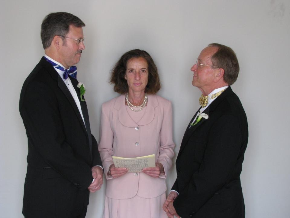 Gene Robinson and Mark Andrew are "married" by a female priest